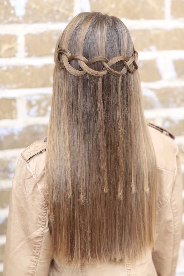 knotted braid, dark blonde hair, how to braid your own hair, brick wall, brown leather jacket 
