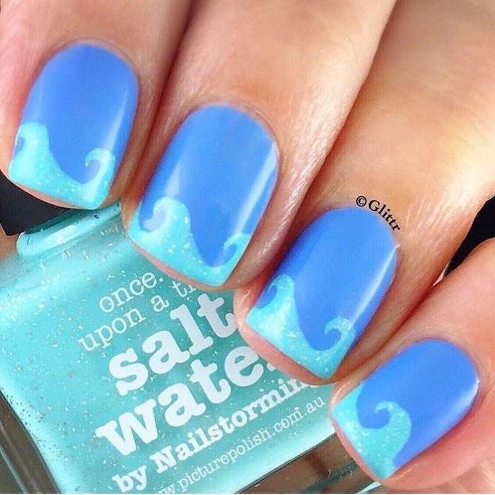 dark blue nail polish, light blue waves, manicure ideas, nail polish bottle