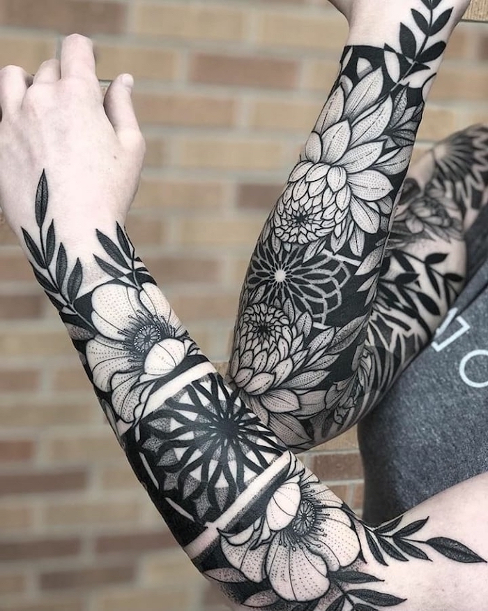 floral tattoos, on both arms, tattoo sleeve ideas for men, brick wall, grey top