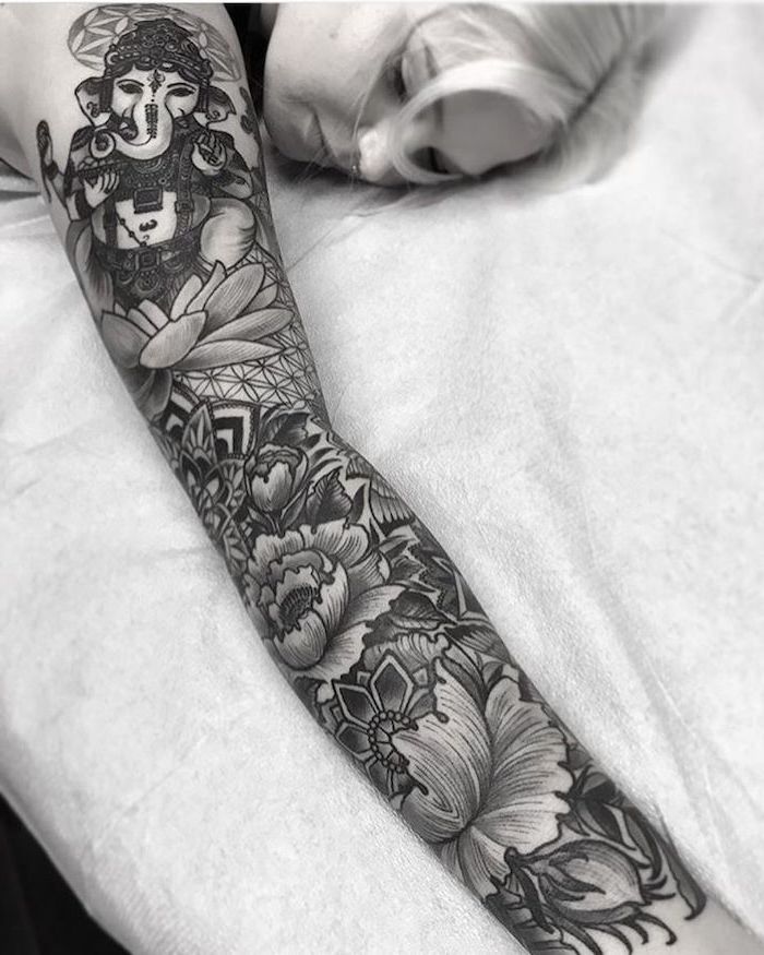 black and white photo, best half sleeve tattoos, ganesha surrounded by flowers, mandala tattoo