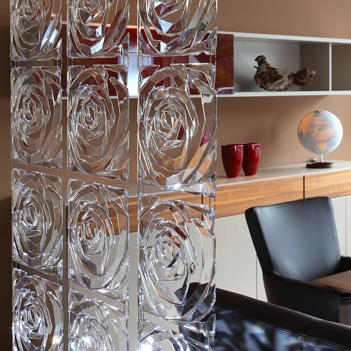 square glass blocks, in the shape of a rose, room divider screen, black leather chairs, wooden shelves