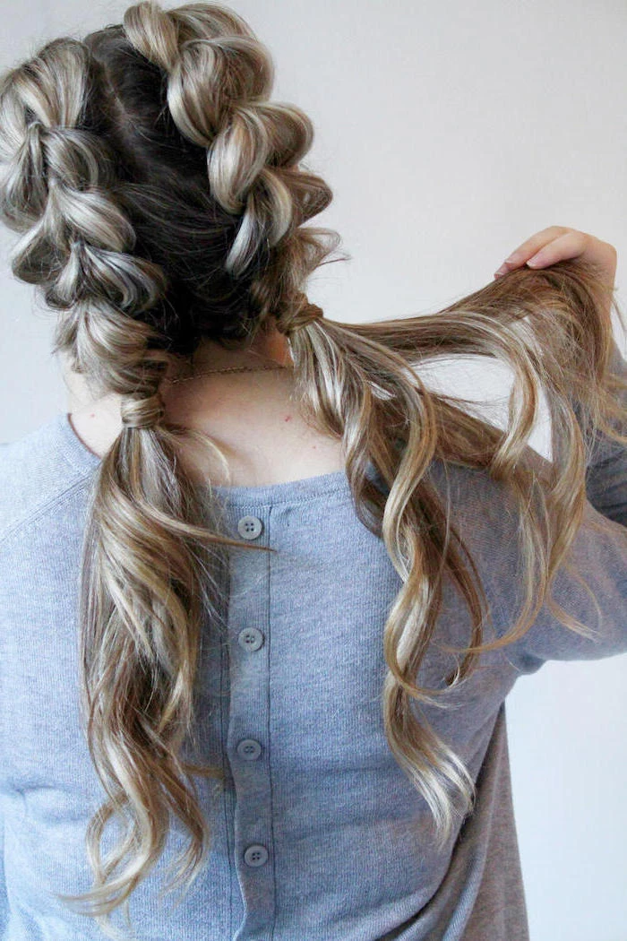 french braid hairstyles, grey cardigan, brown hair, blonde highlights, two braids, two ponytails