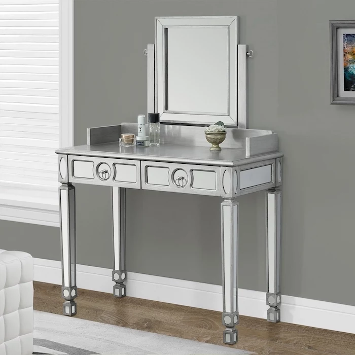 silver metal table, with drawers, square mirror, wooden floor, makeup desk vanity, grey wall