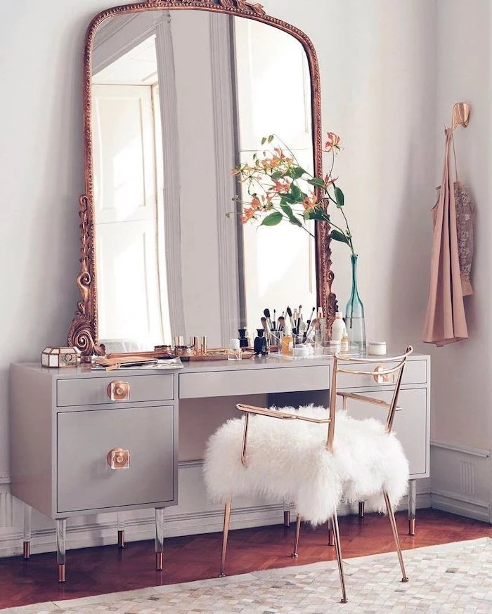 vintage mirror, gold metal chair, white furry cushion, grey drawers, mirrored vanity table