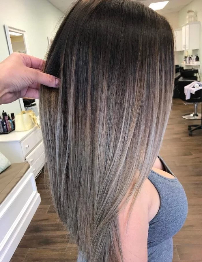 brown to grey, long straight hair, ombre hair brown to blonde, grey top, wooden floor