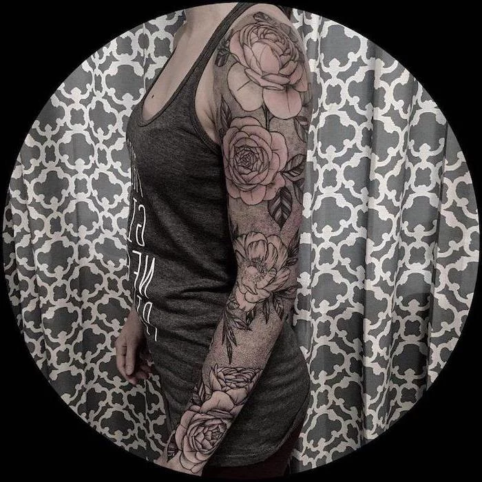 floral tattoo, grey top, grey background, dragon sleeve tattoo