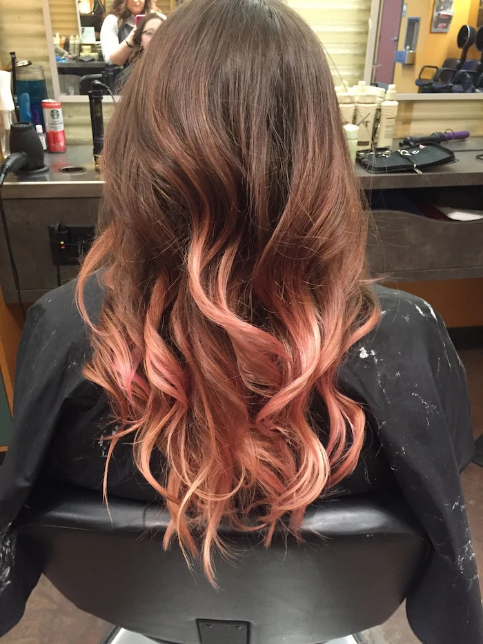 ombre hair brown to blonde, brown to rose gold, long wavy hair, black leather chair