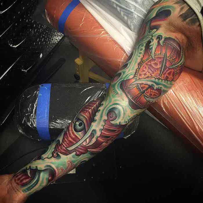 coloured biomechanical, lion tattoo sleeve, leather armchairs