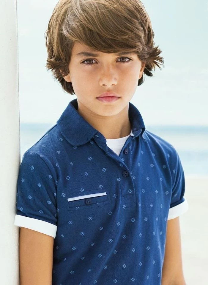 little boy, wearing a blue shirt, brown hair, medium length, short guy haircuts