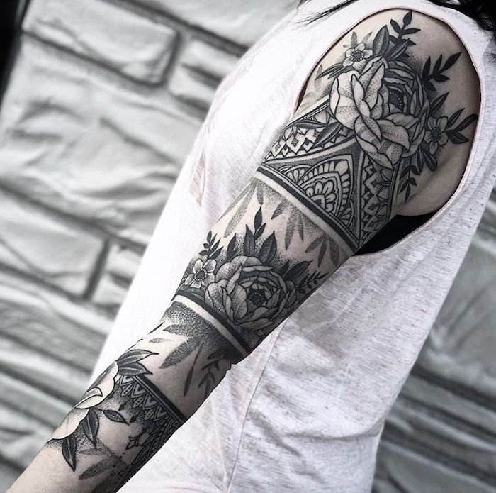 floral mandala, skull sleeve tattoo, grey top, black and white photo, tiled wall