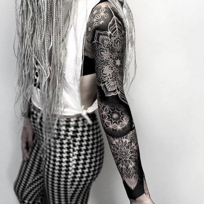 mandala tattoo, skull sleeve tattoo, white top, black and white pant, white background
