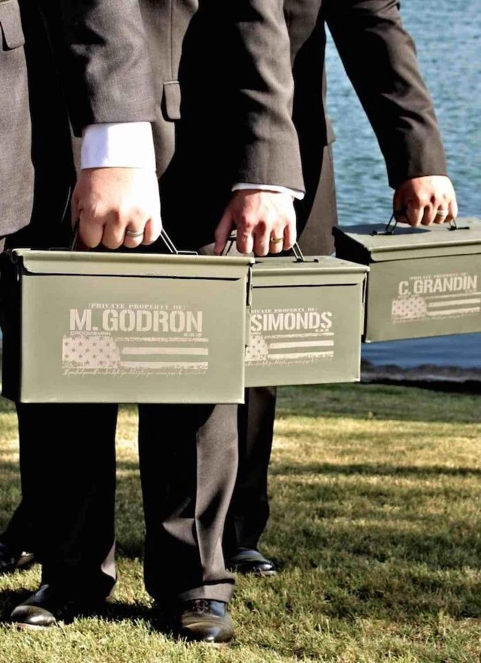 three men, wearing black suits, good groomsmen gifts, metal ammo boxes, personalised with names, usa flag