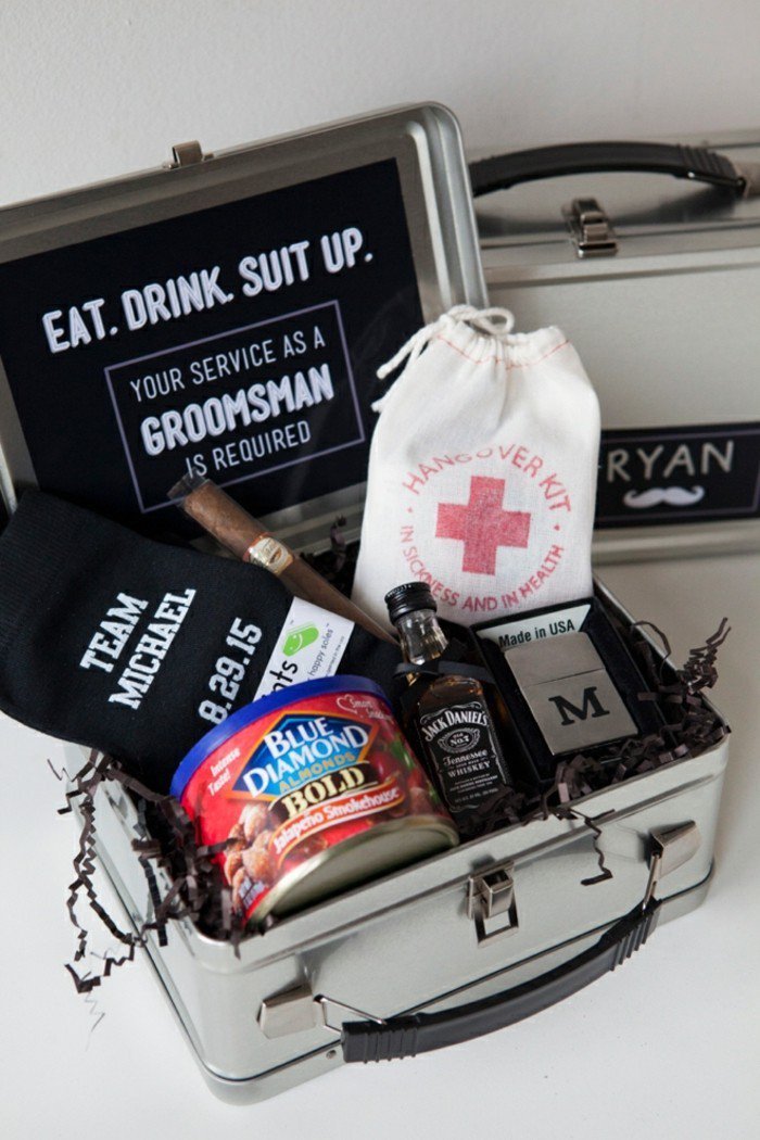 metal box, hangover kit, socks and almonds, bottle of whiskey, cigar and a lighter, good groomsmen gifts