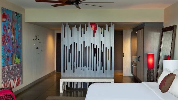 metal poles, arranged together, white bench, room divider shelves, tiled floor, abstract art
