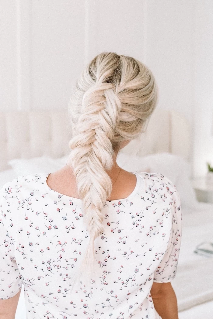 blonde hair, fishtail braided ponytail, floral top, how to braid, white background