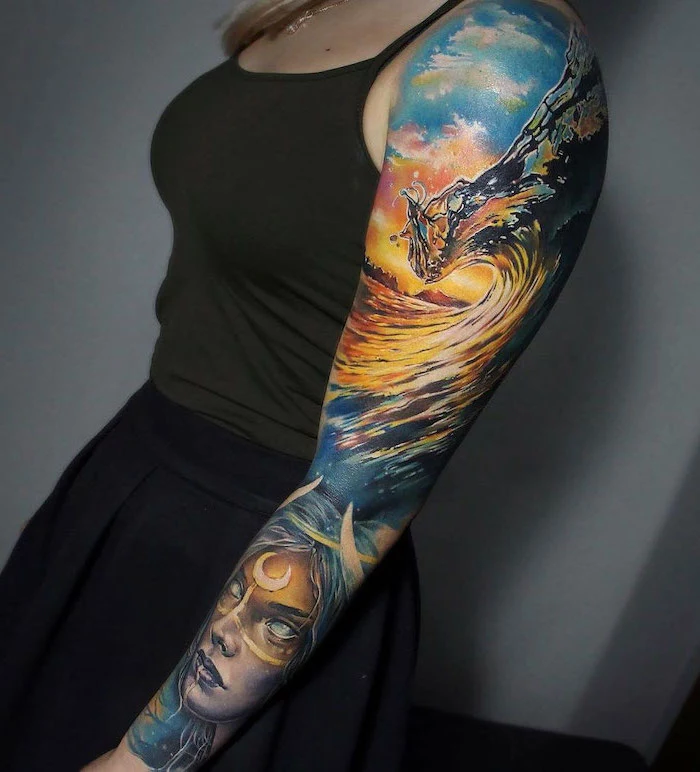 ocean waves, female face, forearm sleeve tattoo, watercolour tattoo, olive green top, grey background