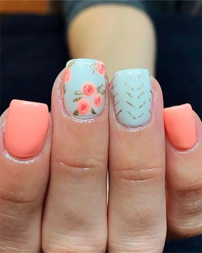 pink and blue nail polish, pink flowers, silver glitter, summer acrylic nails, blurred background