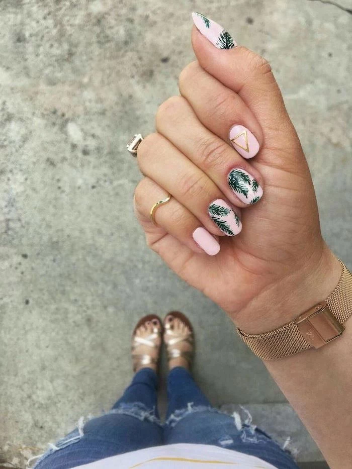 pink nail polish, green leaves, golden triangle, gold watch, blurred background, nail design ideas