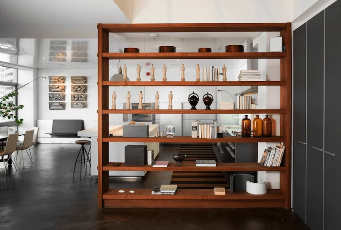 wooden bookshelf, folding room dividers, white chairs, kitchen island, metal bar stools