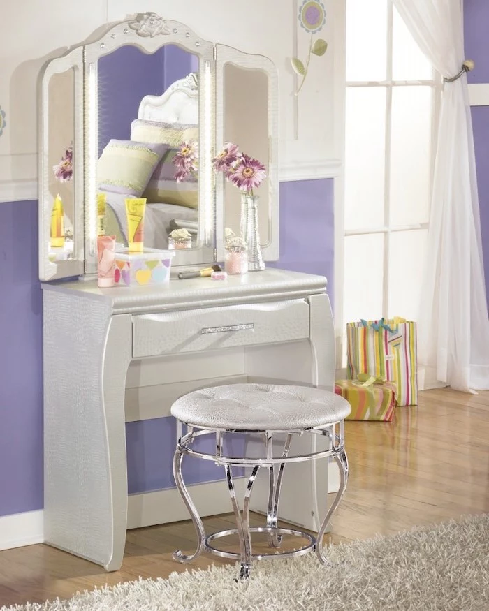 purple walls, white leather table, with drawer, three fold mirror, small makeup vanity, white leather stool