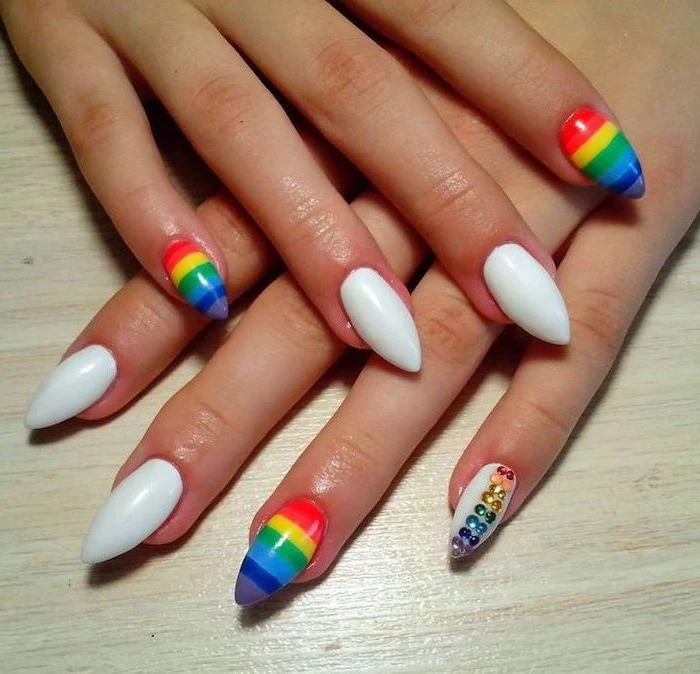 white nail polish, rainbow colored nails, cute short nails, wooden table