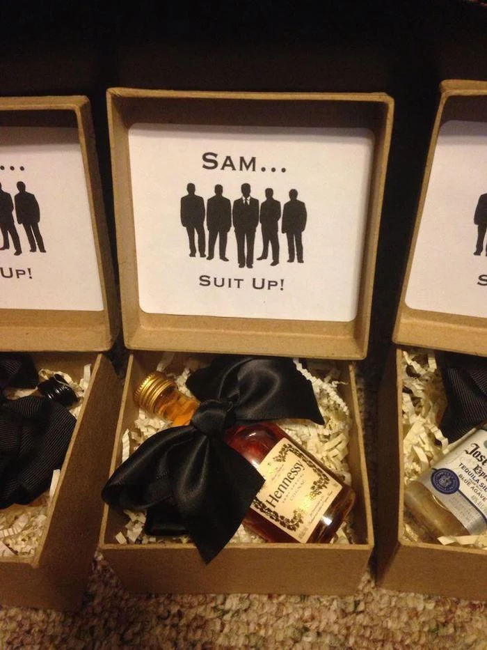 carton box, suit up, bottle of henessy, with black satin bow, groomsmen proposal
