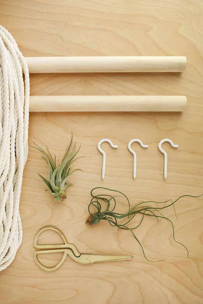 step by step, diy tutorial, wooden poles, white rope, metal hooks, wooden background, room separator