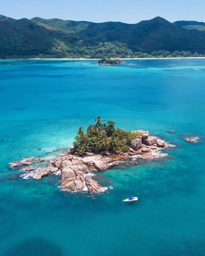 seychelles islands, blue ocean water, small boat, photographed from above