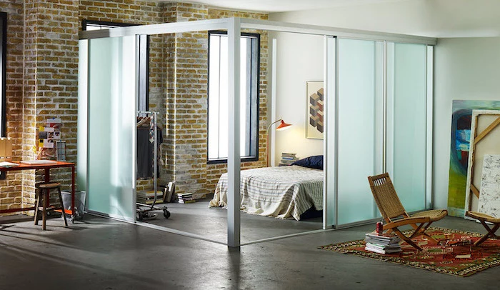 frosted glass, sliding panels, room divider bookcase, wooden armchairs, brick wall, cement floor