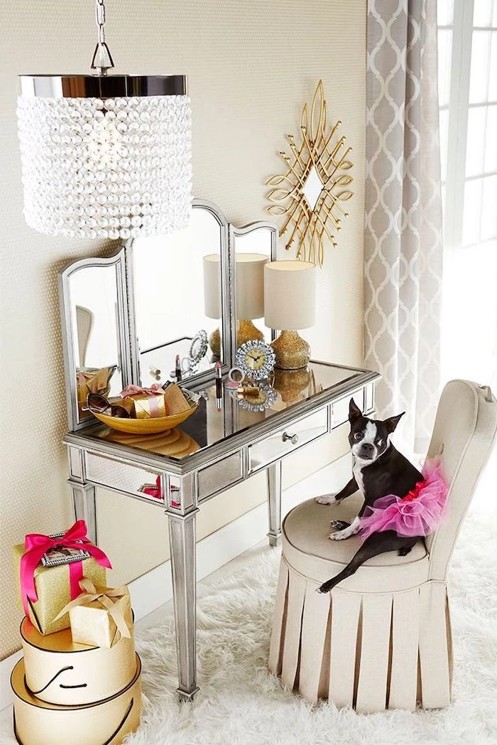 mirrored table, white chair, dog sitting on it, corner makeup vanity, three fold mirror