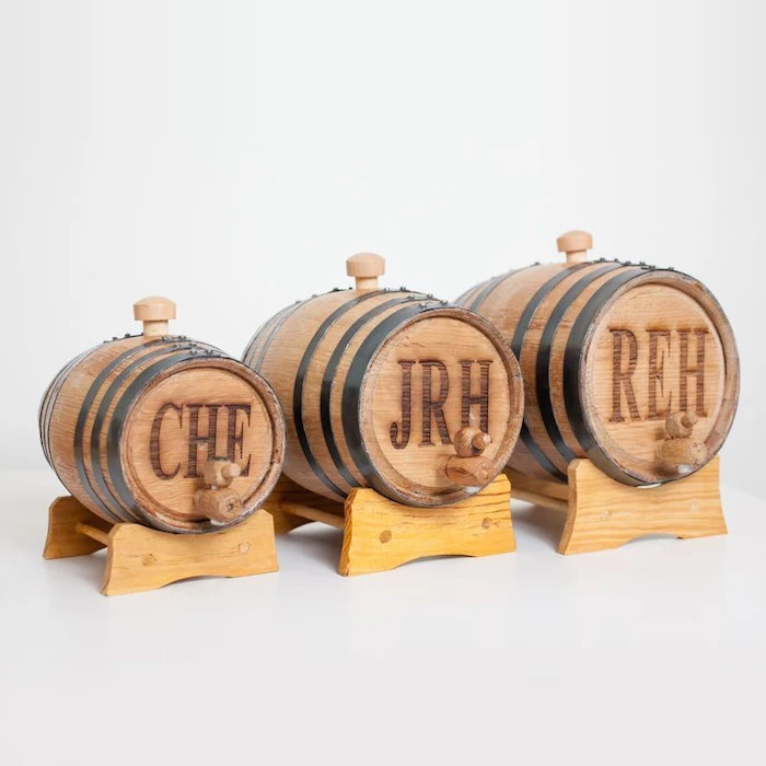 small wooden, whiskey barrels, personalised with initials, groomsmen watches, white background