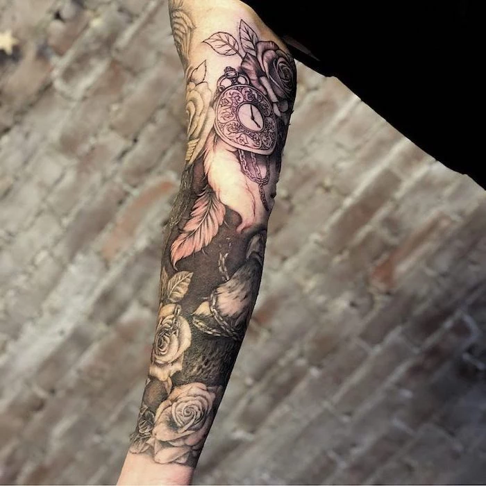 brick wall, religious tattoo sleeve, flowers and stopwatch, black top