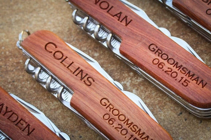 wooden swiss knives, personalised with names and dates, groomsmen watches, brown background