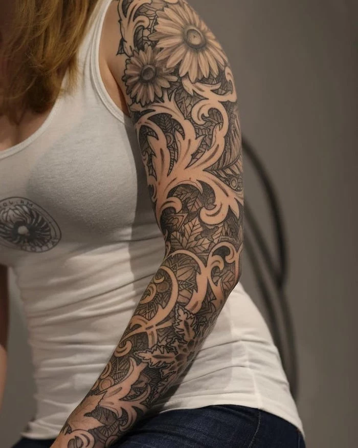white top, floral tattoo, tribal sleeve tattoos, white background