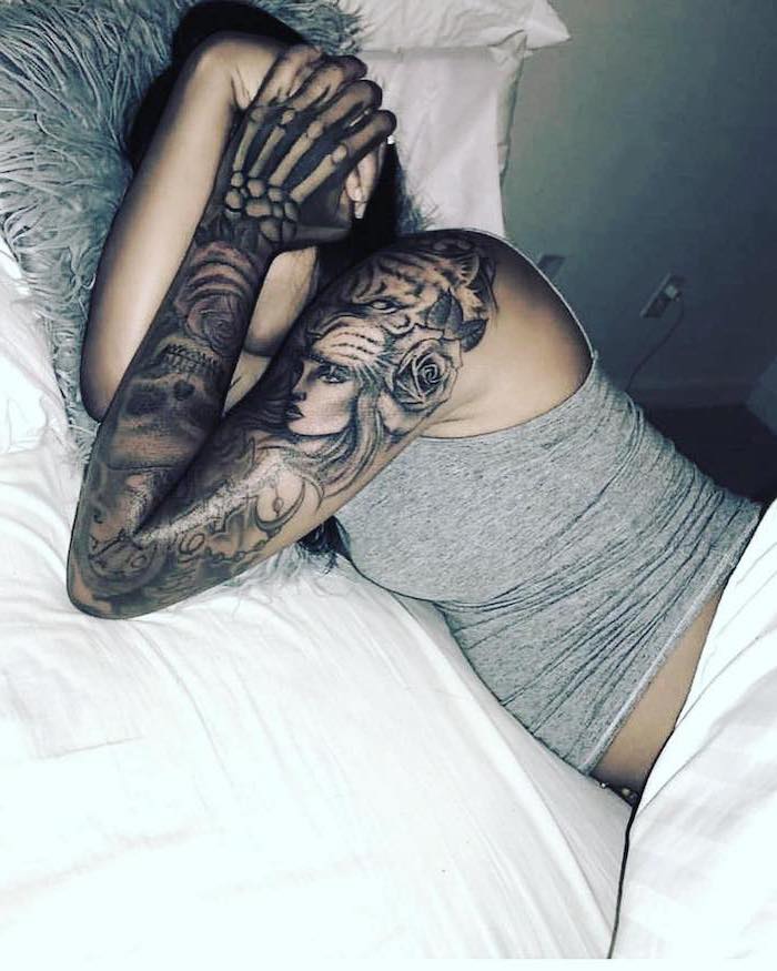 woman in bed, white bed linen, grey top, skulls and roses, sleeve tattoos for guys, black hair