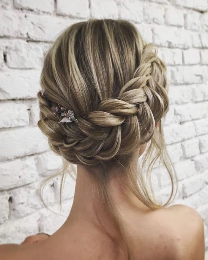 white brick wall, how to do a waterfall braid, blonde hair, with highlights, braided updo