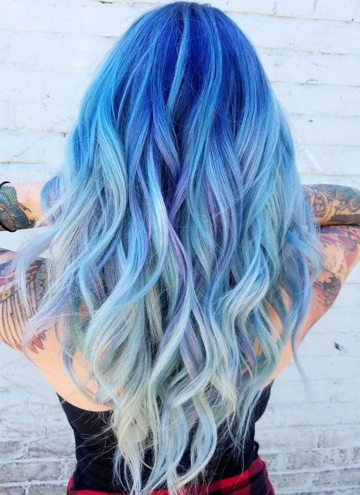 sleeve tattoos, dark blue to light blue and purple, long wavy hair, what is ombre hair, white brick wall