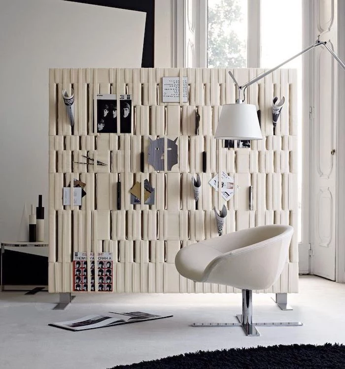 white leather panel, covered in magazines and vinyl, room divider doors, white armchair