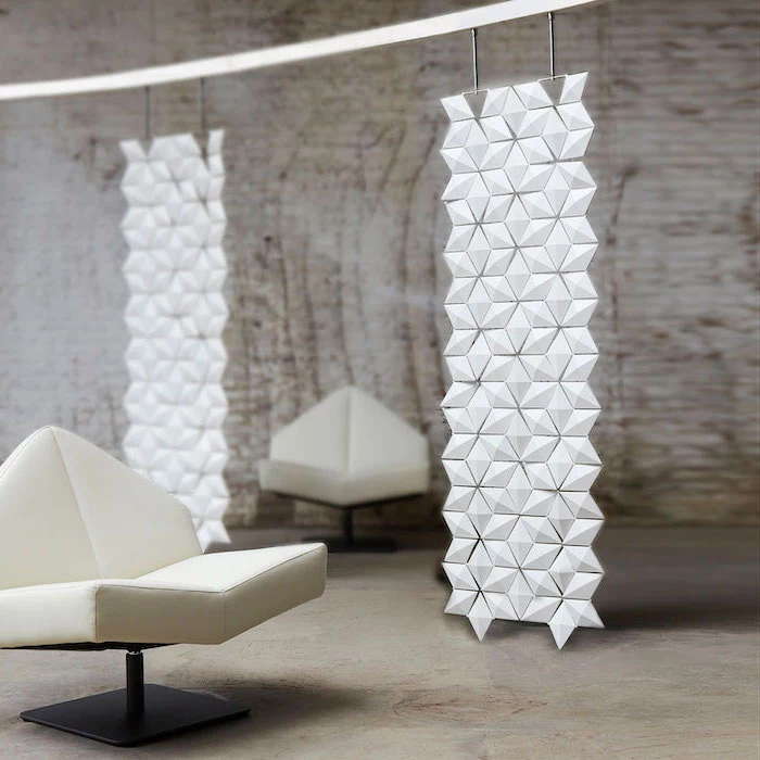 geometrical hanging panels, room divider doors, white armchairs, industrial style