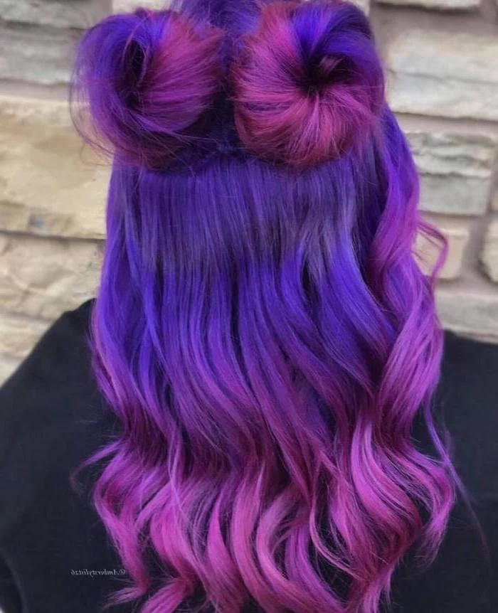 purple to pink, in two buns, long wavy hair, brown and blonde ombre, white stone wall