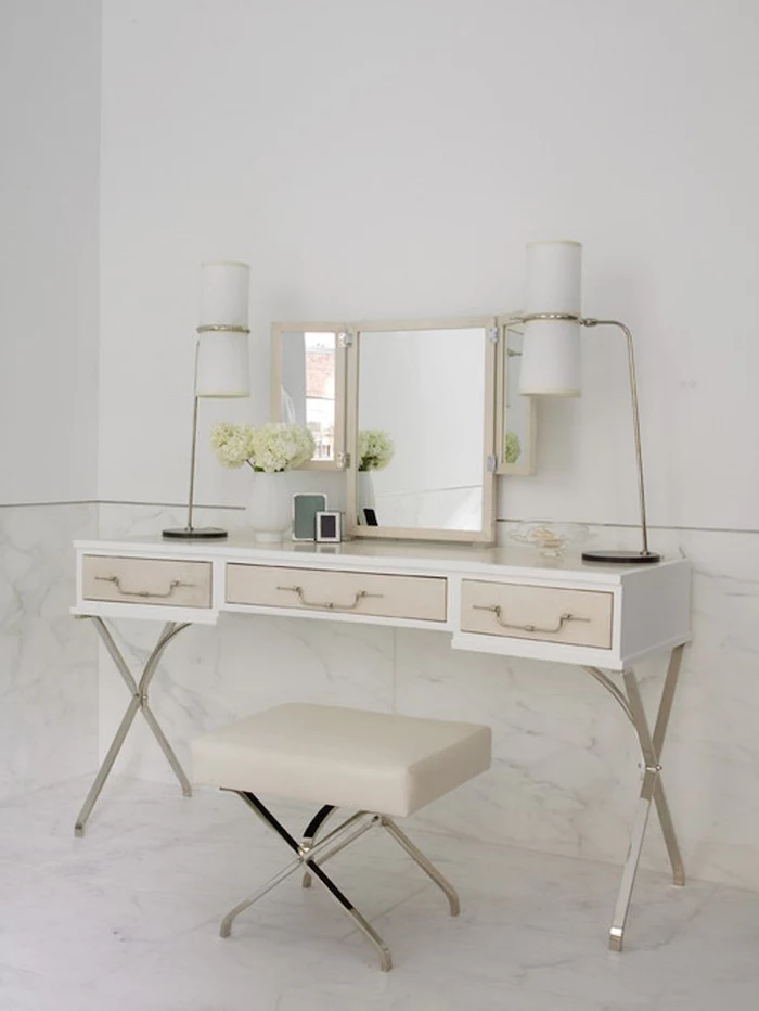 white walls, marble floor, modern makeup vanity, white with beige drawers, beige leather stool