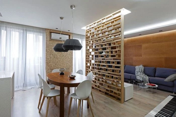 wooden blocks, folding screen room divider, blue sofa, wooden wall, mosaic wall, wooden floor, white chairs