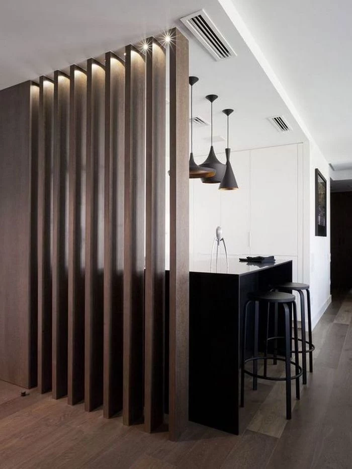 wooden panels, kitchen island, black metal bar stools, indoor privacy screen, wooden floor