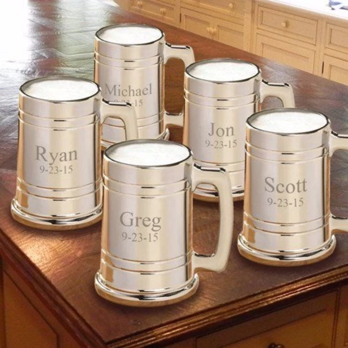 metal beer mugs, how to ask groomsmen, personalised with names and dates, on a wooden table