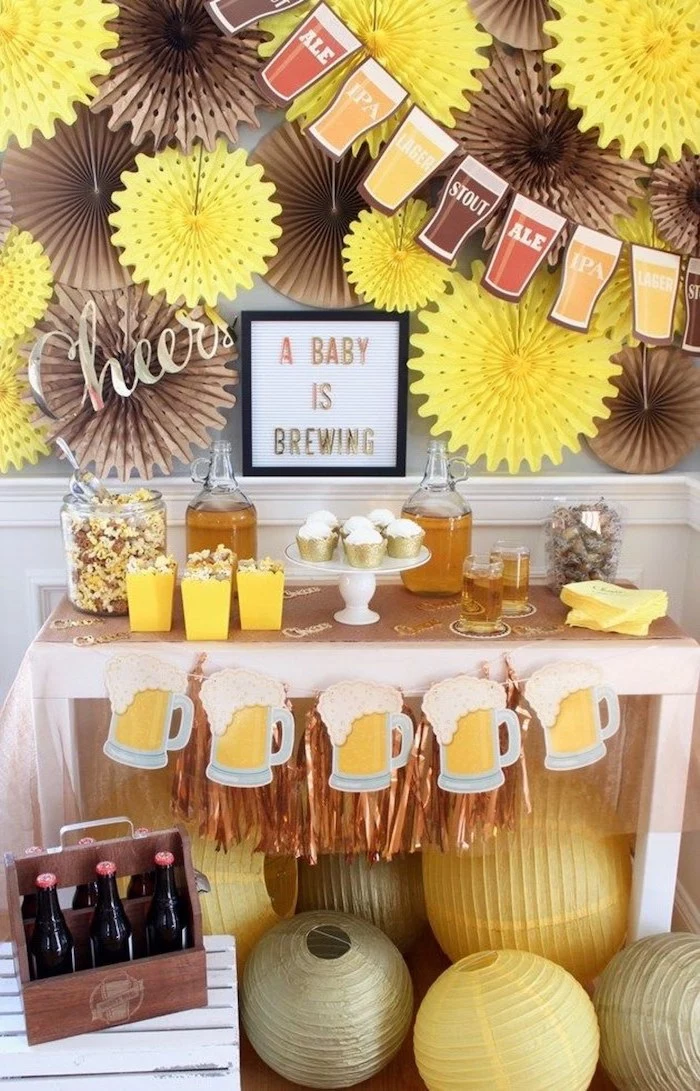 a baby is brewing, beer theme, baby shower decoration ideas, brown and yellow decor, cupcakes and popcorn