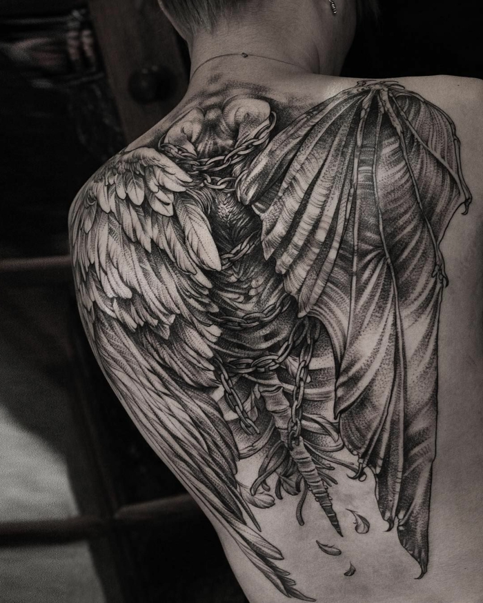 angel and devil wing tattoo, large back tattoo of wings and bones, black and white photo