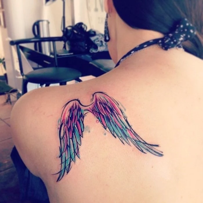 watercolor tattoo, angel wings tattoo, shoulder tattoo, woman with black hair, black earrings