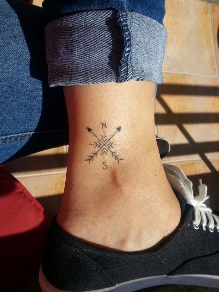 compass tattoo, ankle tattoo, girl wearing jeans, black sneakers
