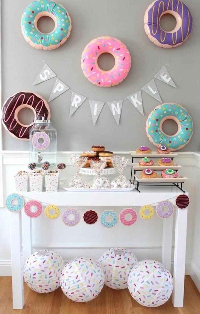 sprinkle garland, donuts theme, donut balloons, baby shower decoration ideas, white wooden table, dessert table