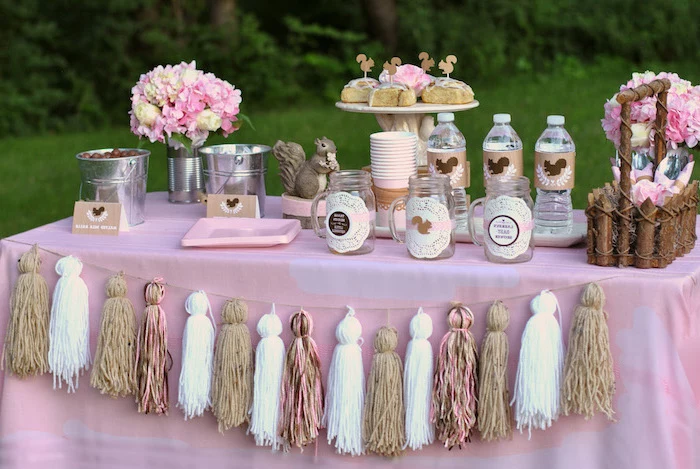 tassel garland, rustic decor, pink brown and white, baby shower decoration ideas, water bottles, cinnamon buns